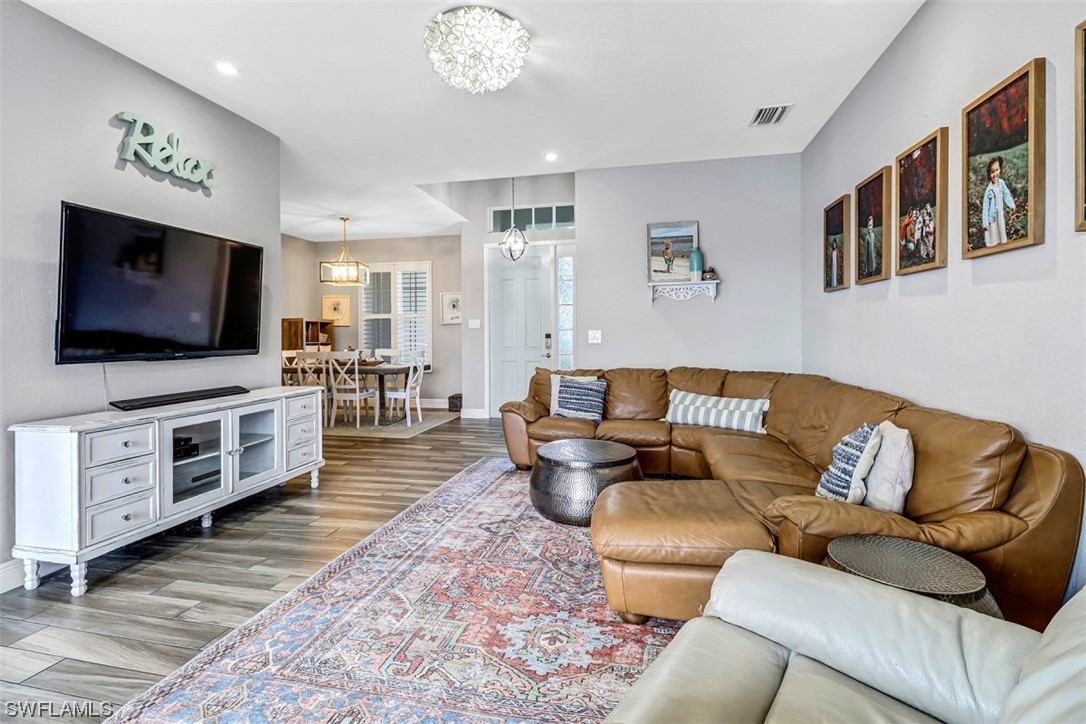 3944 Ruxton Road Naples, FL 34116 - Photo 9 of 23 a living room with furniture and a flat screen tv