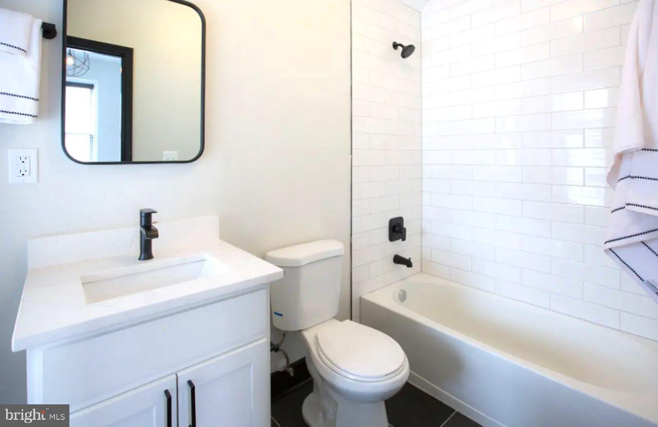 938 North Calvert Street, Unit 1B Baltimore, MD 21202 - Photo 10 of 11 a bathroom with a sink toilet and shower