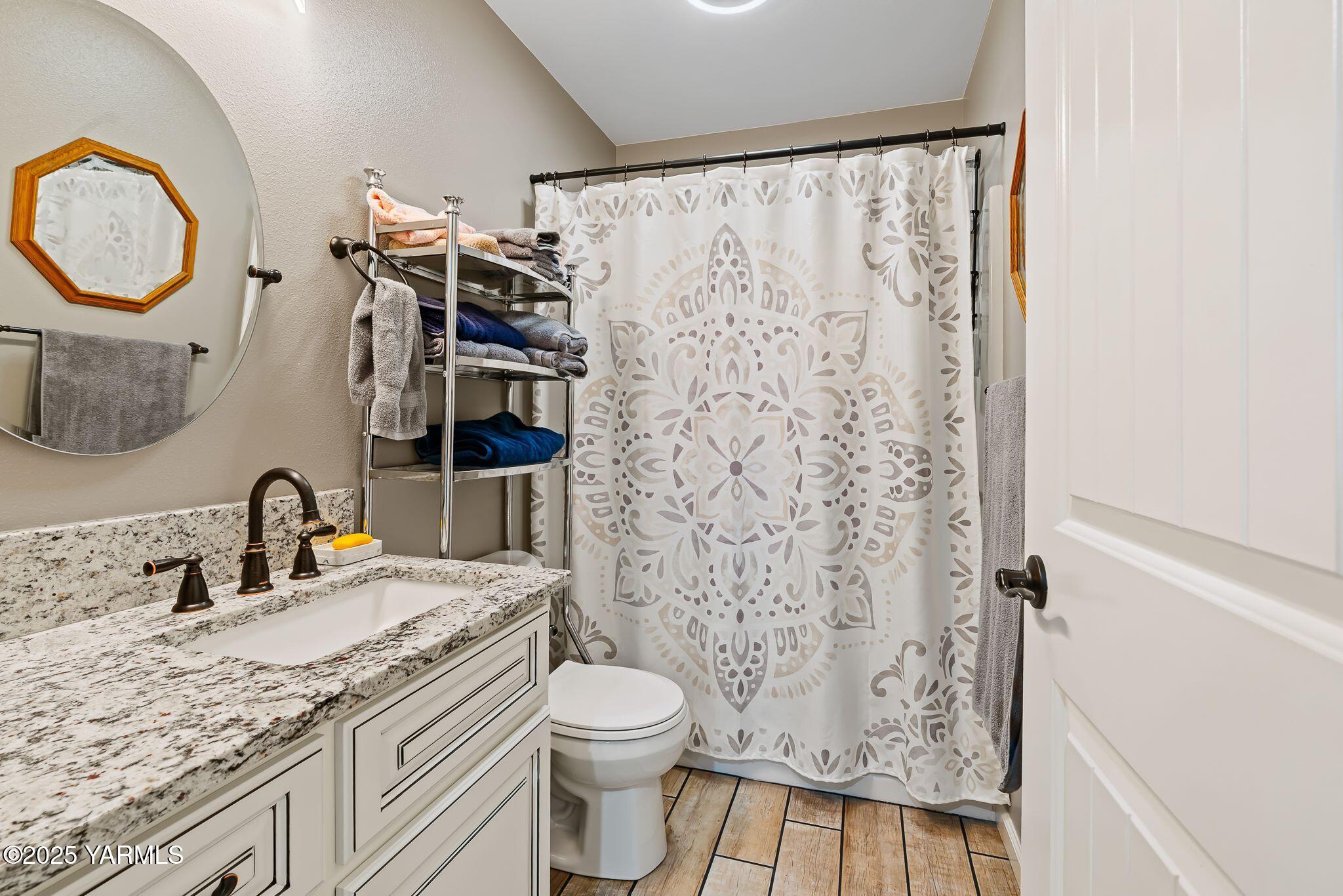 2005 Jennifer Drive Granger, WA 98932 - Photo 15 of 26 a bathroom with a granite countertop sink toilet and shower