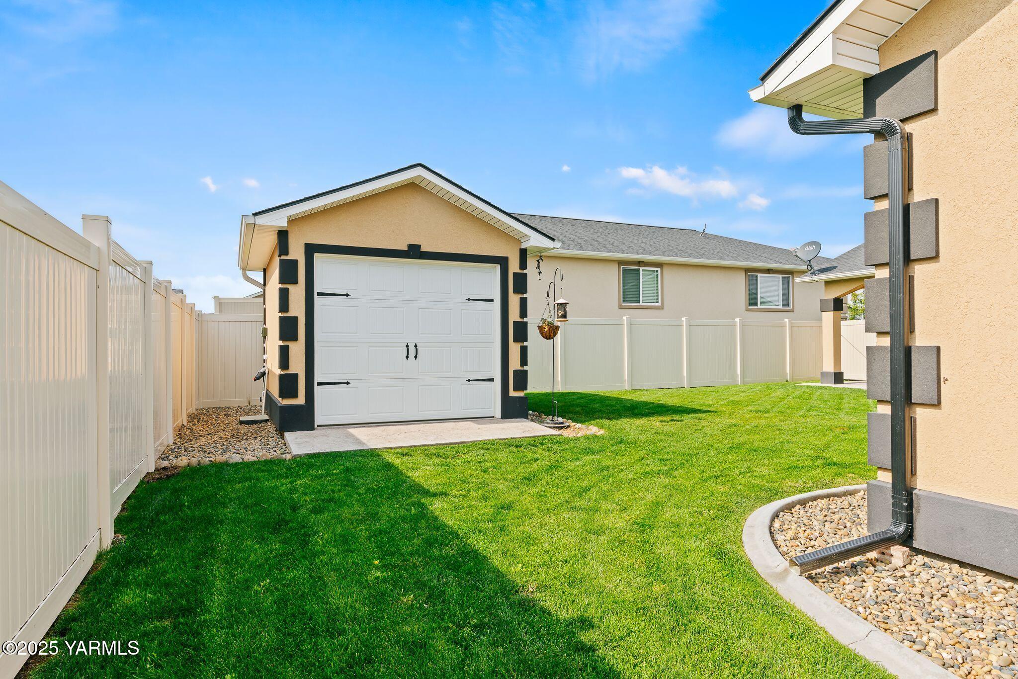 2005 Jennifer Drive Granger, WA 98932 - Photo 26 of 26 a view of a backyard with a garden and garage