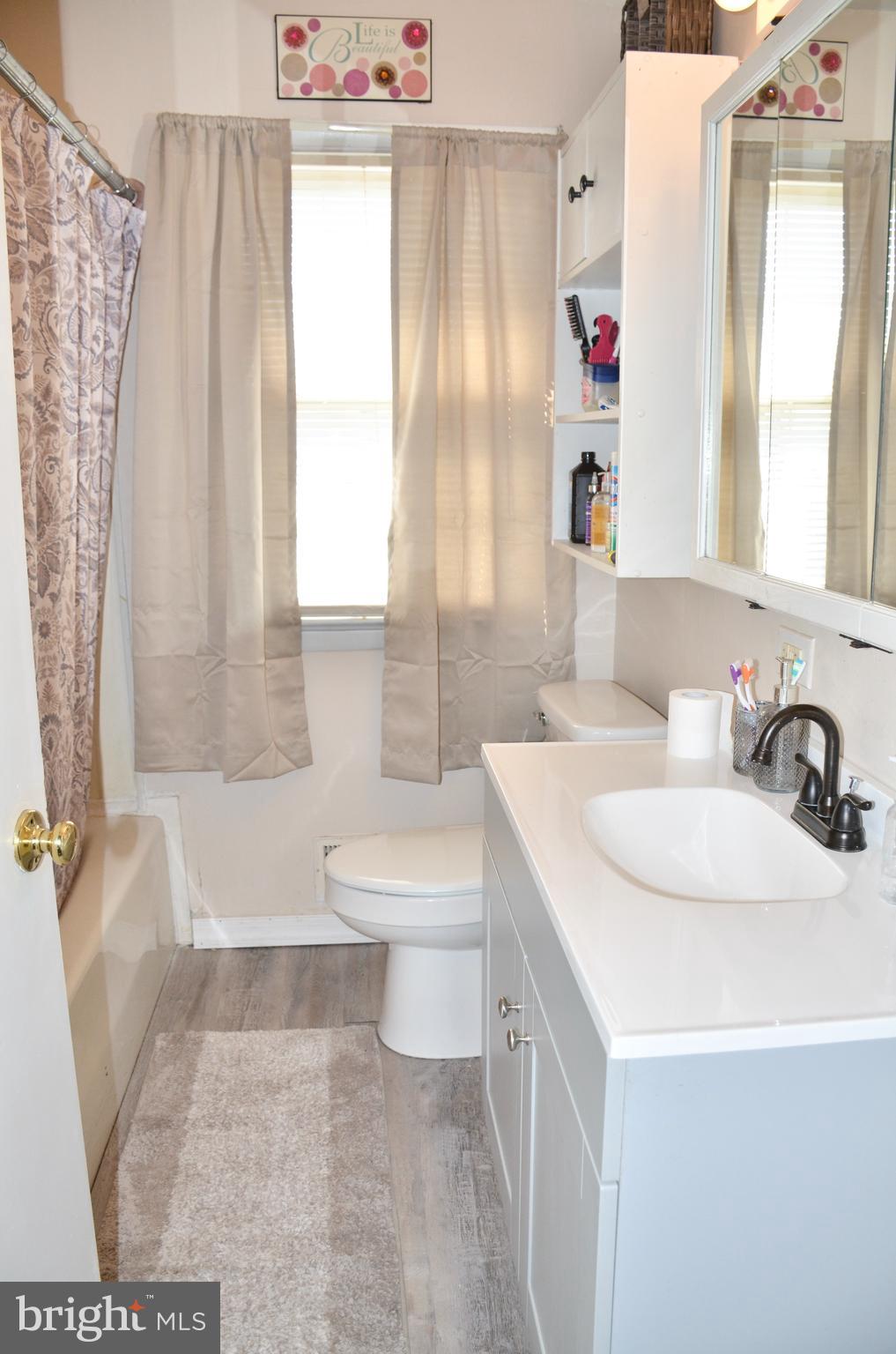 36 Harvard Road Pennsville, NJ 08070 - Photo 11 of 31 a bathroom with a sink a toilet and a tub