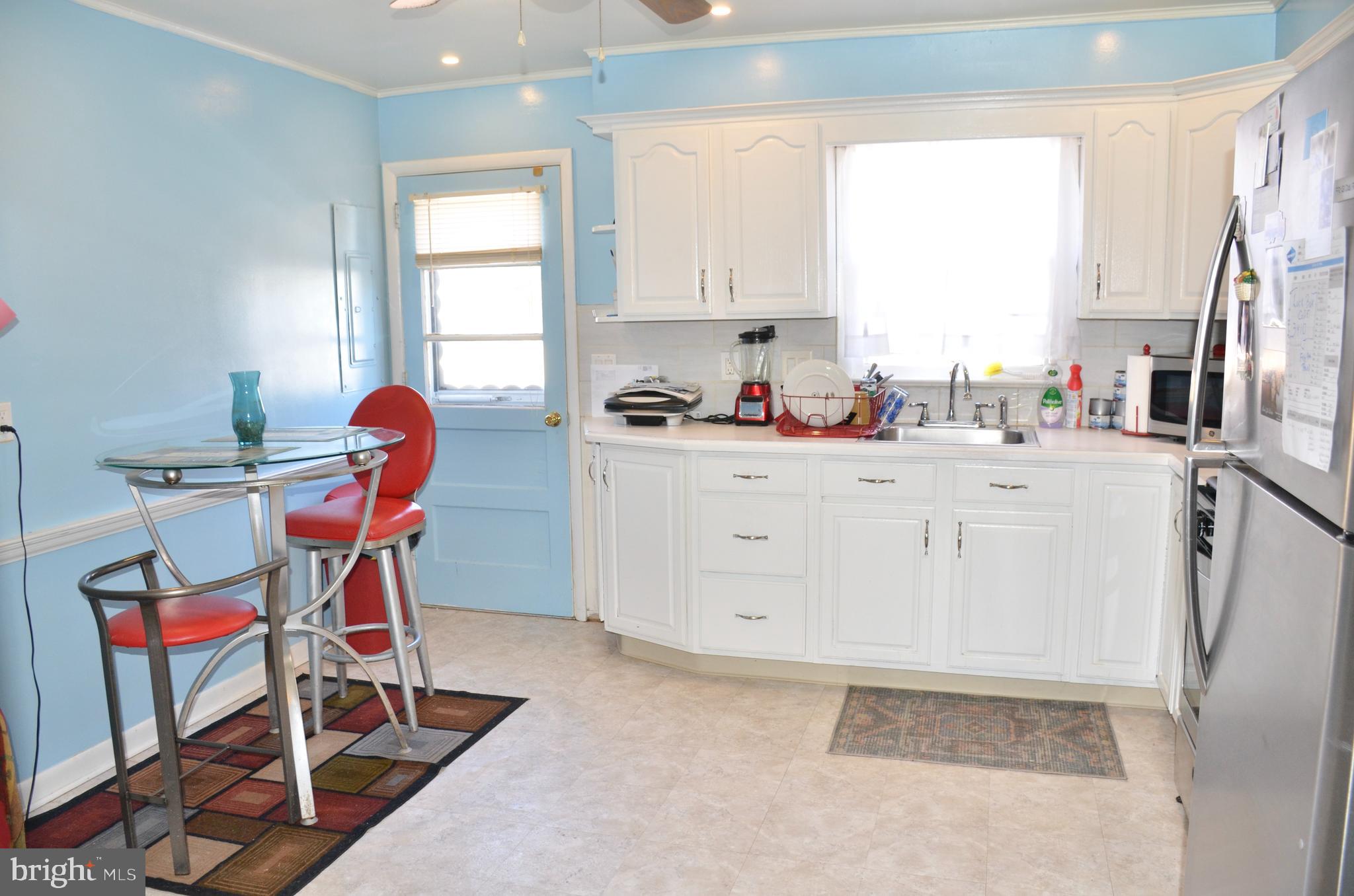 36 Harvard Road Pennsville, NJ 08070 - Photo 3 of 31 a kitchen with stainless steel appliances a stove a sink cabinets and a window
