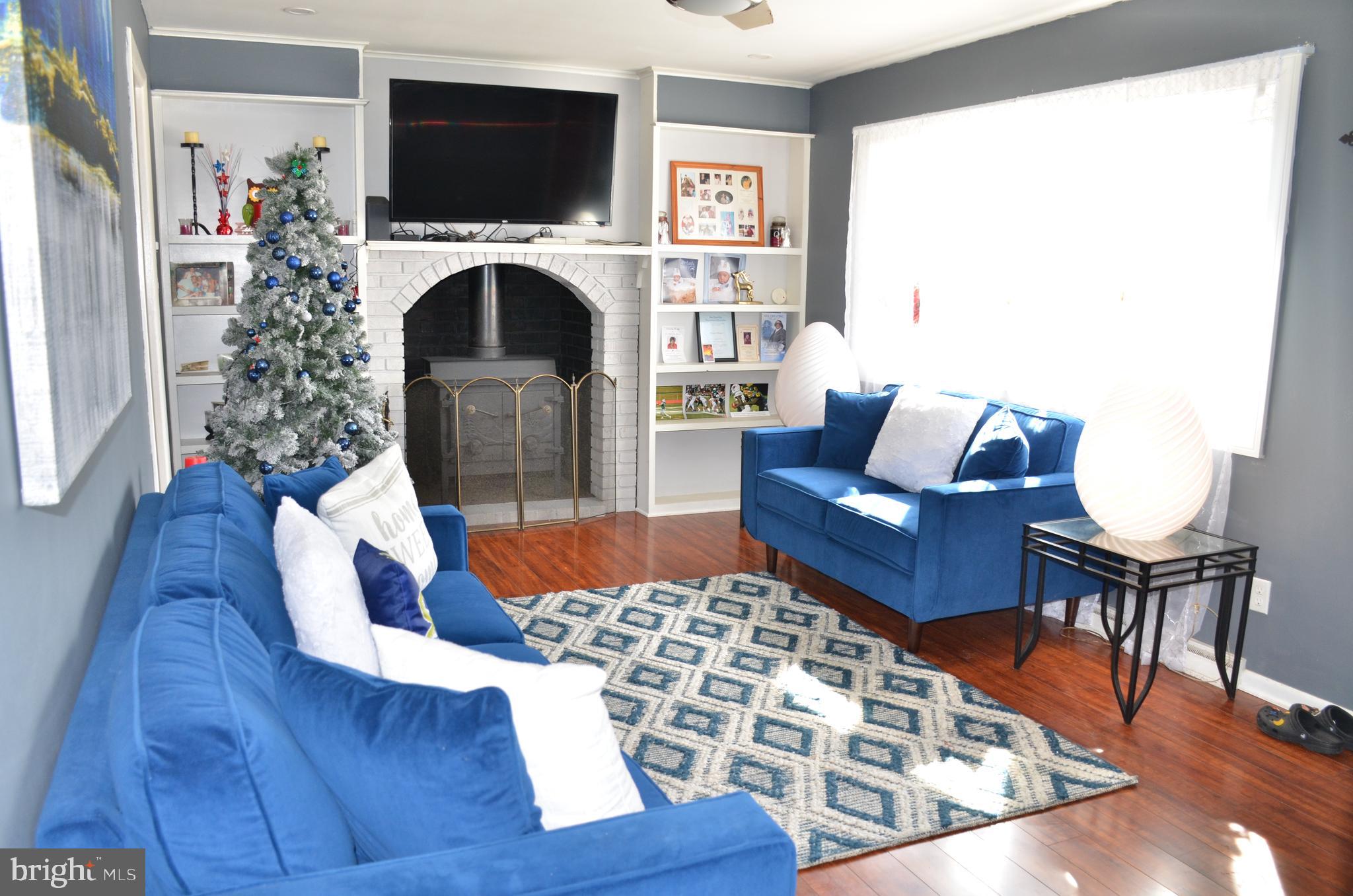 36 Harvard Road Pennsville, NJ 08070 - Photo 5 of 31 a living room with furniture a flat screen tv and a fireplace