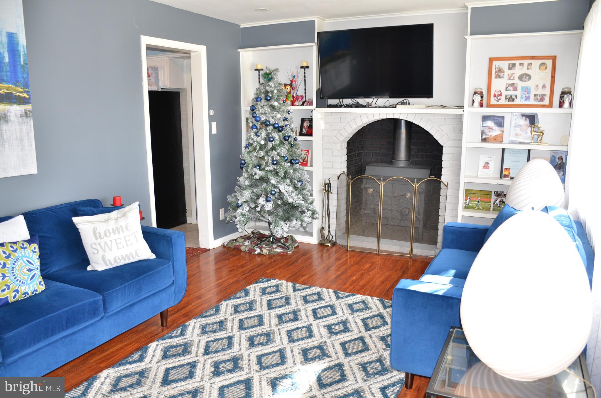 36 Harvard Road Pennsville, NJ 08070 - Photo 6 of 31 a living room with a flat screen tv and a fireplace