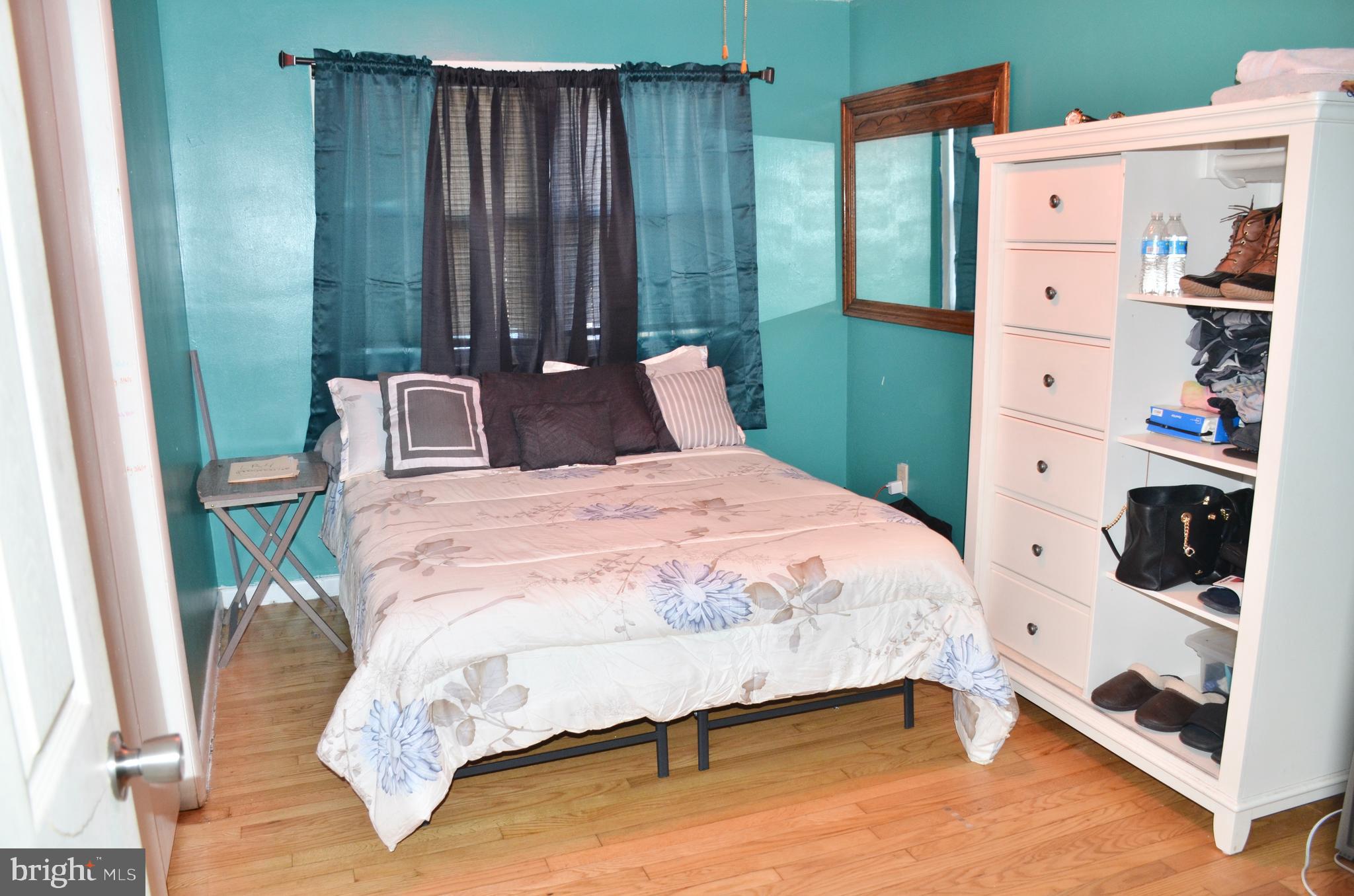 36 Harvard Road Pennsville, NJ 08070 - Photo 8 of 31 a bedroom with a bed wooden floor and window