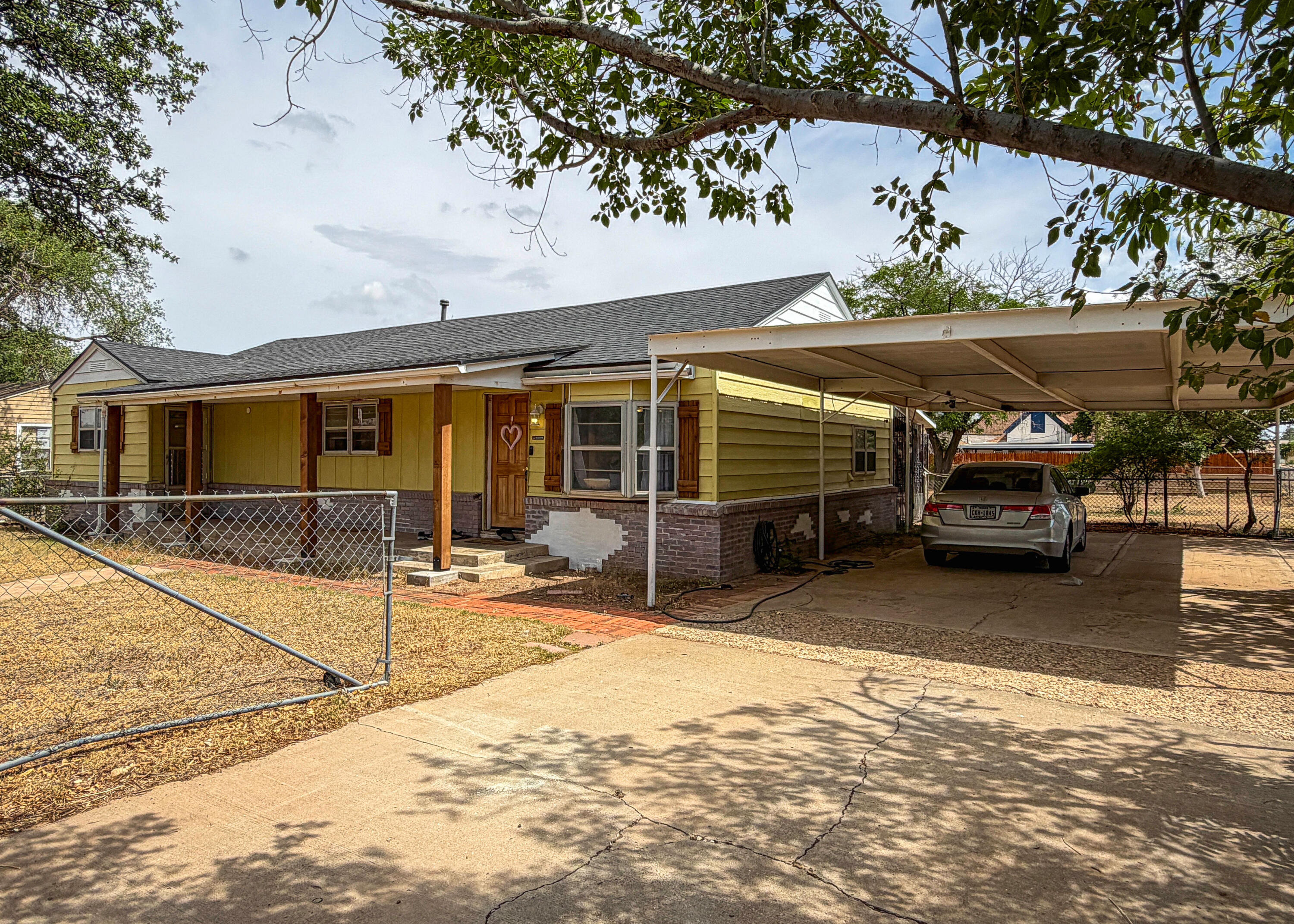 3221 Emory Street Lubbock, TX 79415 - Photo 2 of 15 a view of a car park in front of house