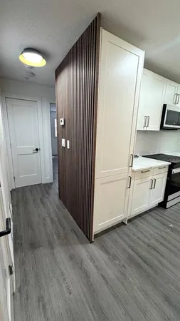 a view of a kitchen with kitchen island a sink wooden floor and outdoor view