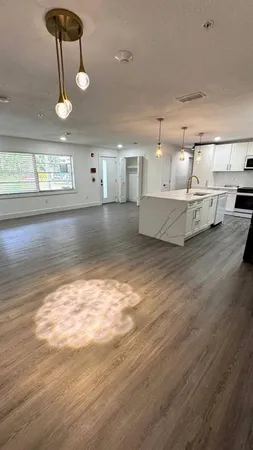 a view of a room with wooden floor and window
