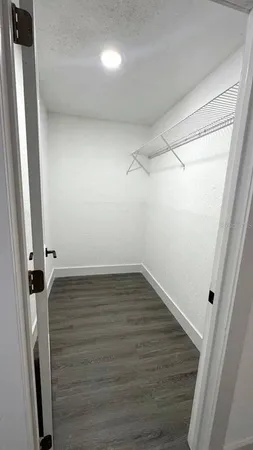 a view of a room with wooden floor