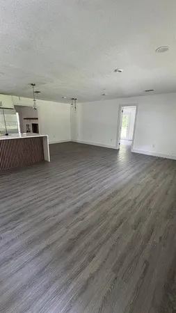 a view of a room with wooden floor