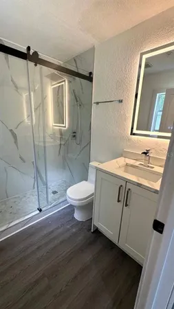a bathroom with a toilet and a shower