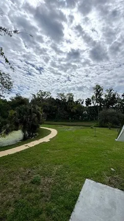 a view of a field of grass and trees