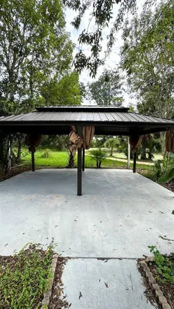 a view of a field with a tree in the background