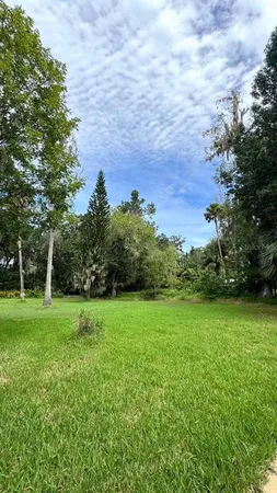 an aerial view of a house with a yard and garden