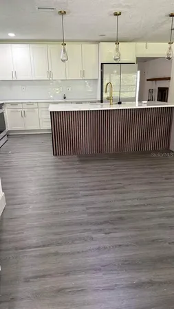a bathroom with a granite countertop sink toilet a mirror and shower