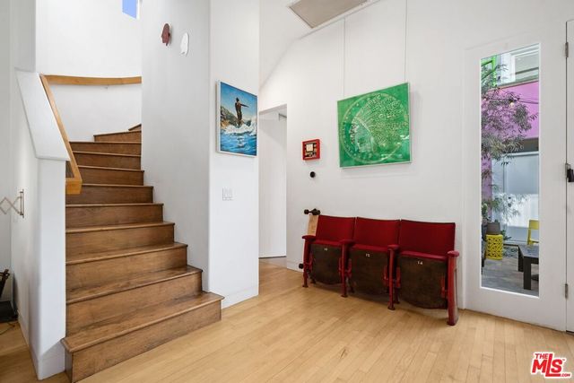 a bedroom with bed and a large window