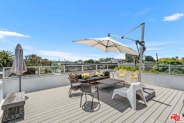 a view of a house with a yard and potted plants