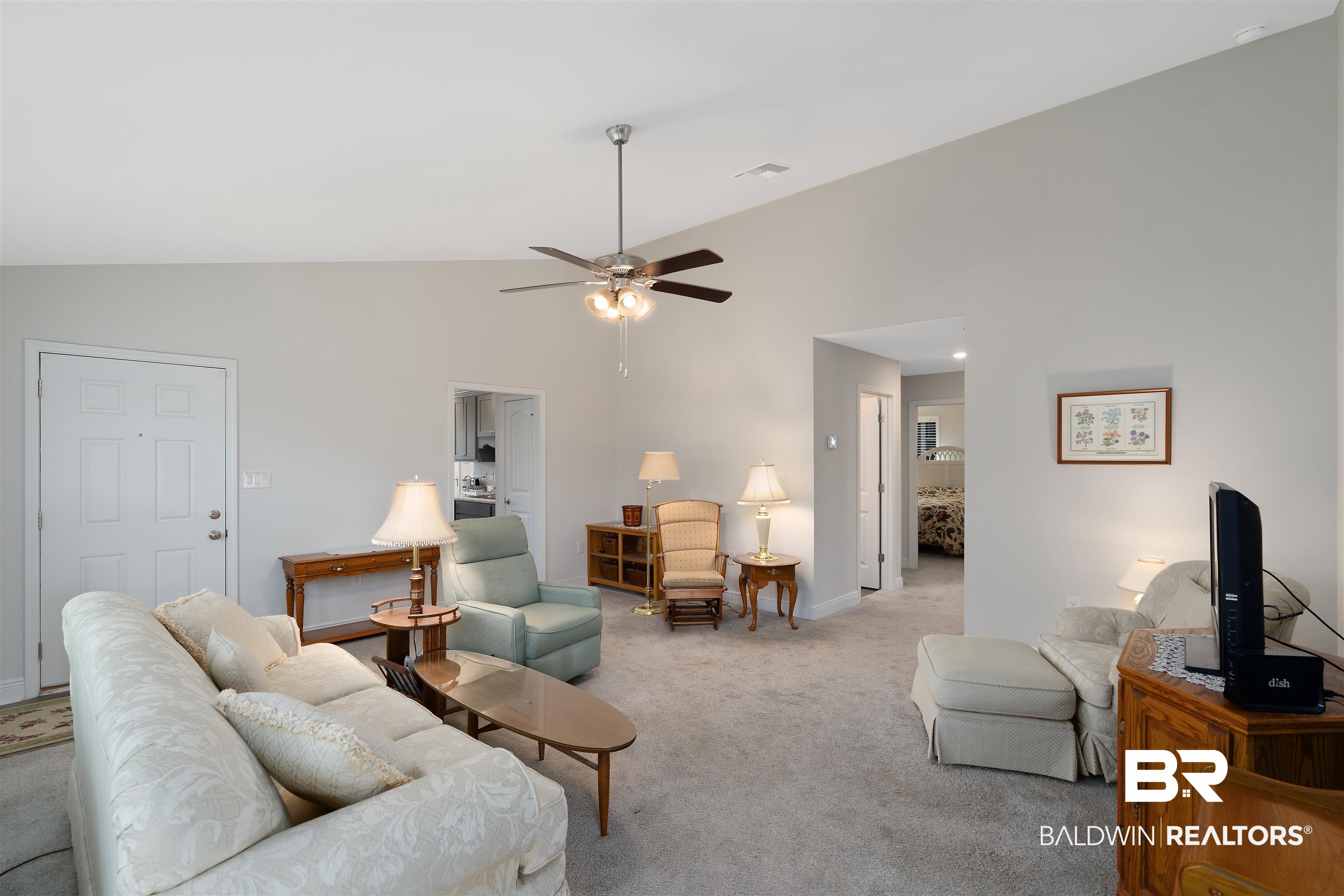 8823 Allay Lane Foley, AL 36535 - Photo 6 of 18 Carpeted living room featuring high vaulted ceiling and ceiling fan