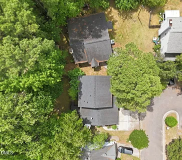 an aerial view of a house with a yard and garden