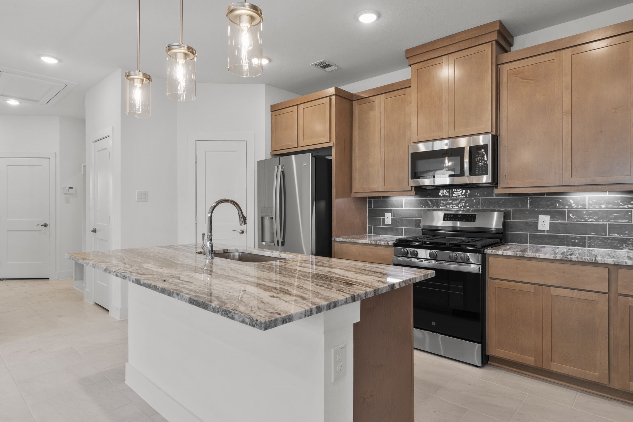 5247 Celestial Court Iowa Colony, TX 77583 - Photo 12 of 39 a kitchen with stainless steel appliances granite countertop a sink a stove and a refrigerator