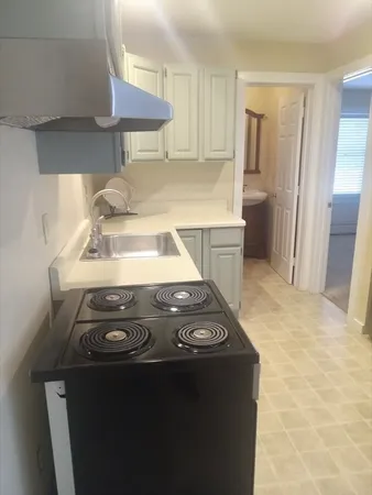 a kitchen with a stove and a refrigerator
