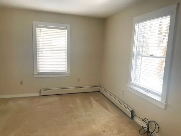 a room with a window and a bicycle