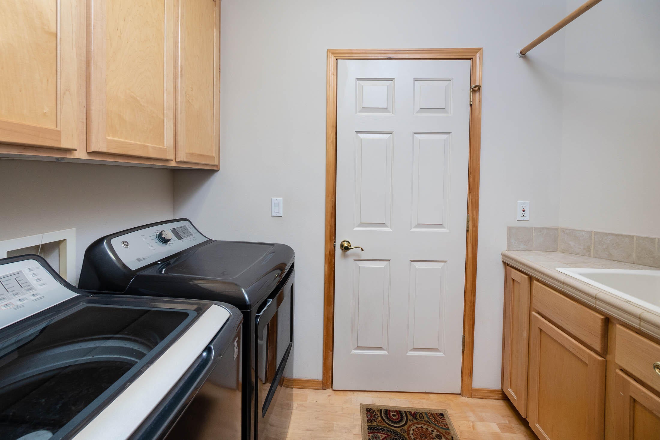 8384 Forest Ridge Loop Redmond, OR 97756 - Photo 12 of 53 Utility room with plenty of cabinet storage and a utility sink.
