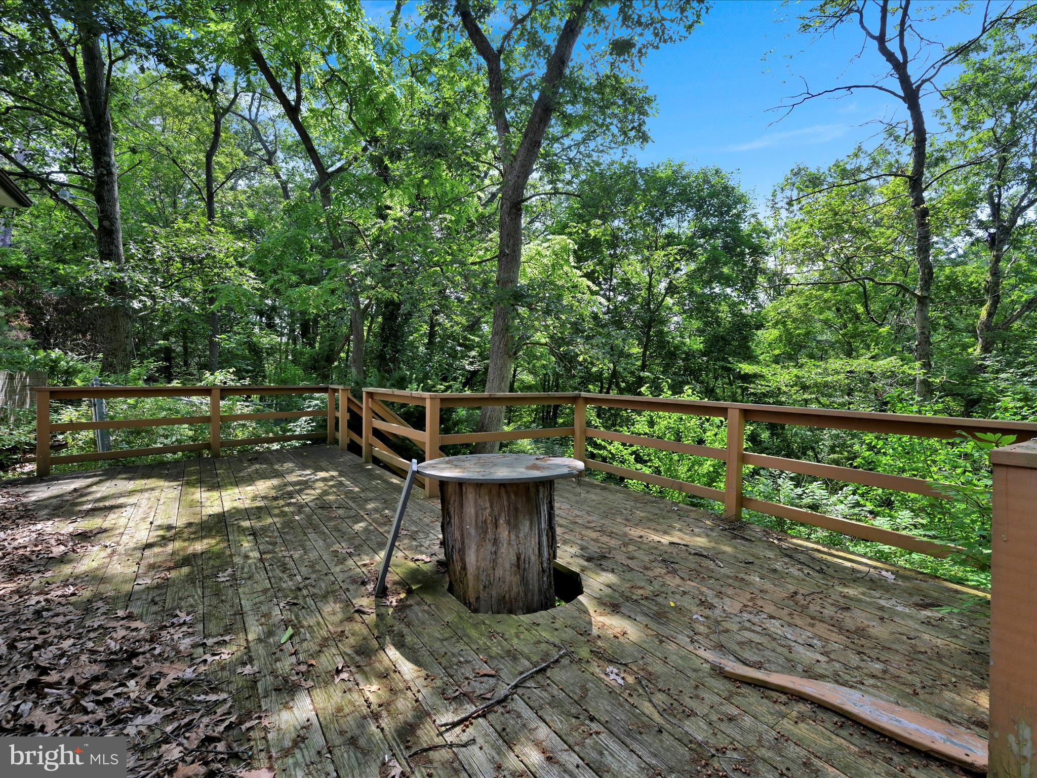 21 Blue Rocks Road Lenhartsville, PA 19534 - Photo 17 of 48 a view of a deck with a chair and floor to ceiling window