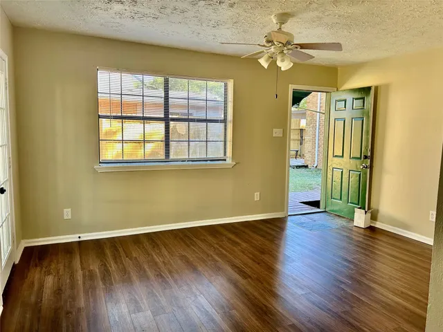an empty room with wooden floor and a window