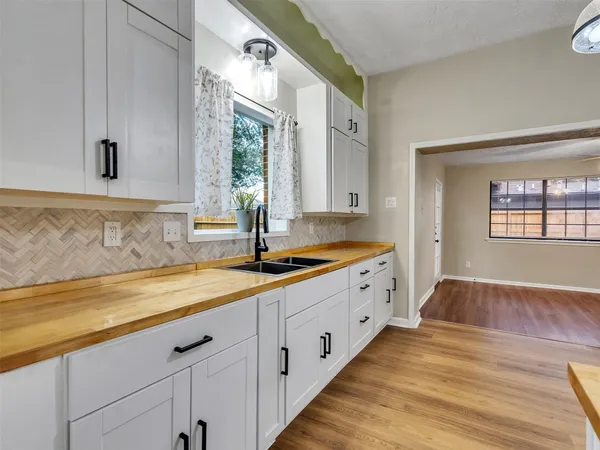 a white refrigerator freezer and a stove sitting inside of a kitchen