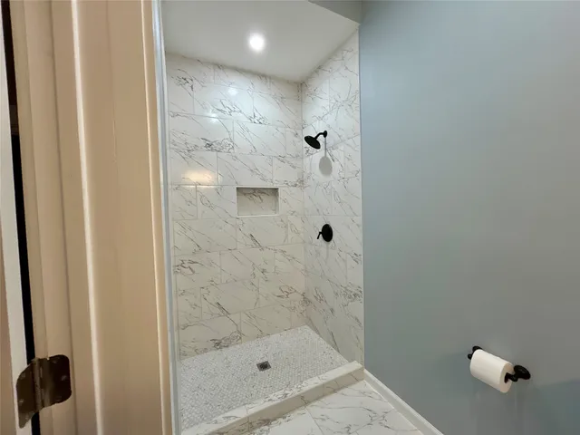 a bathroom with a glass shower door