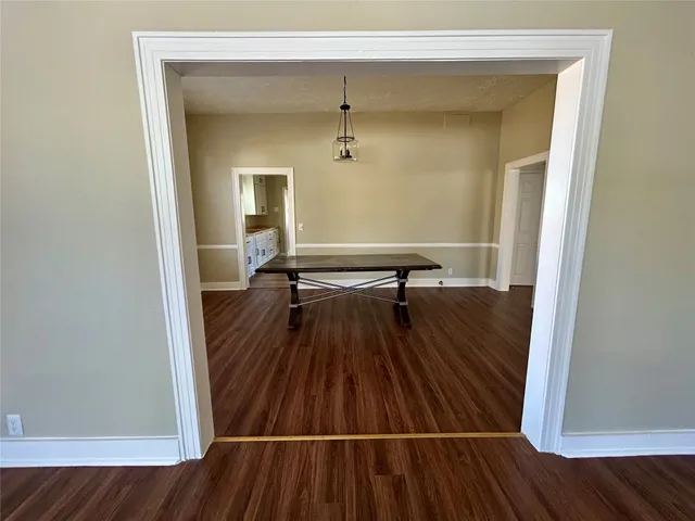 a view of a room with wooden floor and staircase