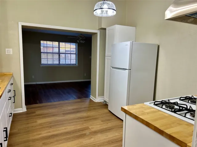 a kitchen with a refrigerator and a stove