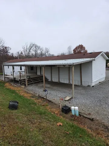 a backyard of a house with table and chairs