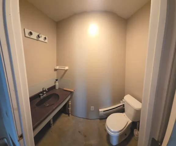 a bathroom with a sink a toilet and a mirror
