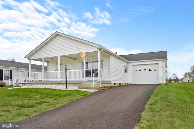 a large kitchen with granite countertop a refrigerator and a stove top oven