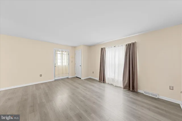 a view of an empty room with a ceiling fan