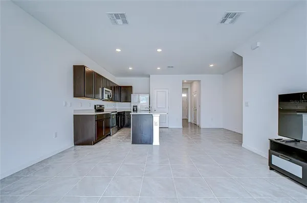 a view of kitchen with stainless steel appliances a refrigerator and a stove top oven