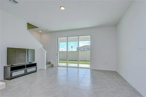 a view of an empty room with a flat screen tv