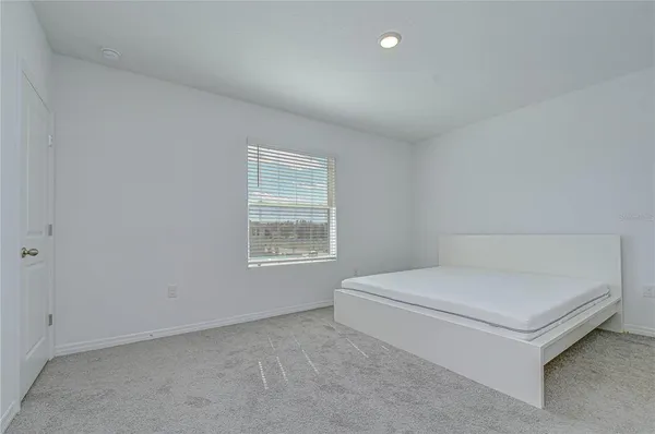 a room with a bed and a window