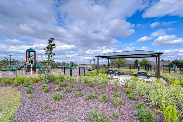 a view of a patio with a table and chairs under an umbrella