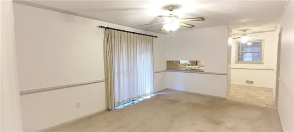 a view of a kitchen with closet and a ceiling fan