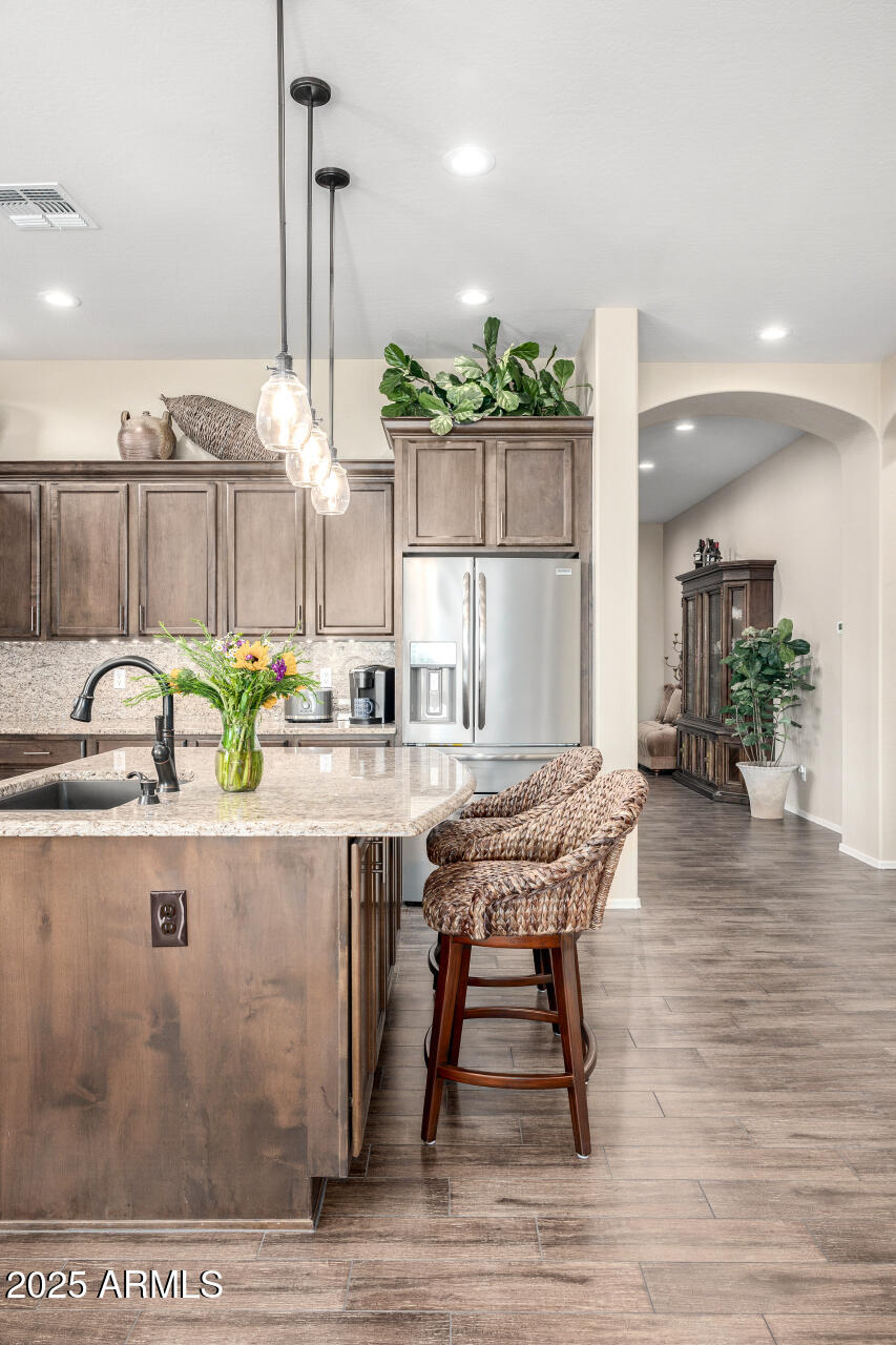 1822 North Waverly Mesa, AZ 85207 - Photo 32 of 91 a dining hall with stainless steel appliances kitchen island granite countertop a dining table chairs and chandelier