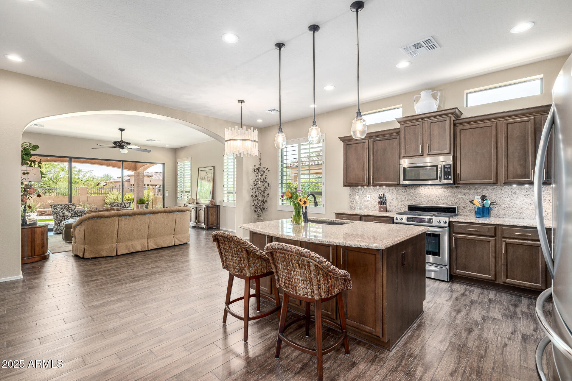 1822 North Waverly Mesa, AZ 85207 - Photo 90 of 91 a kitchen with stainless steel appliances granite countertop a stove and a view of living room