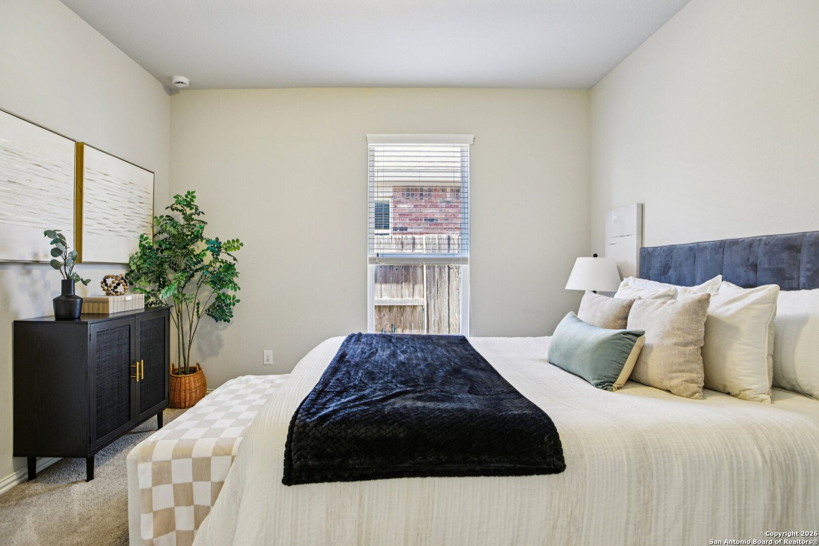 732 Bonnet Boulevard Georgetown, TX 78628 - Photo 25 of 55 a bedroom with a large bed and a potted plant