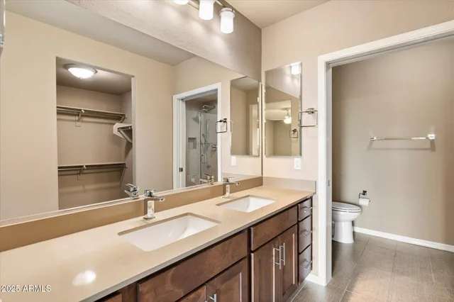 a bathroom with a double vanity sink mirror and double