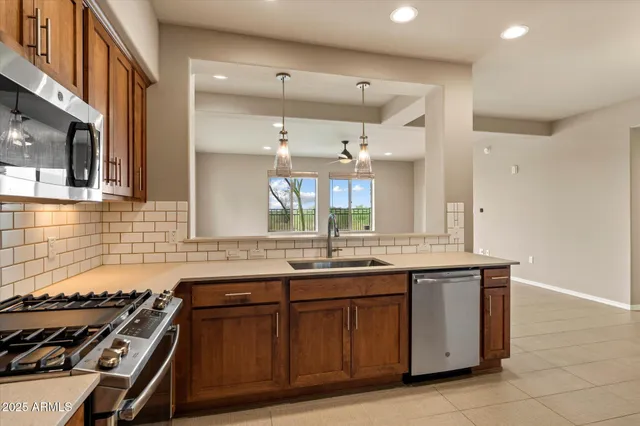 a kitchen with a sink stove and cabinets