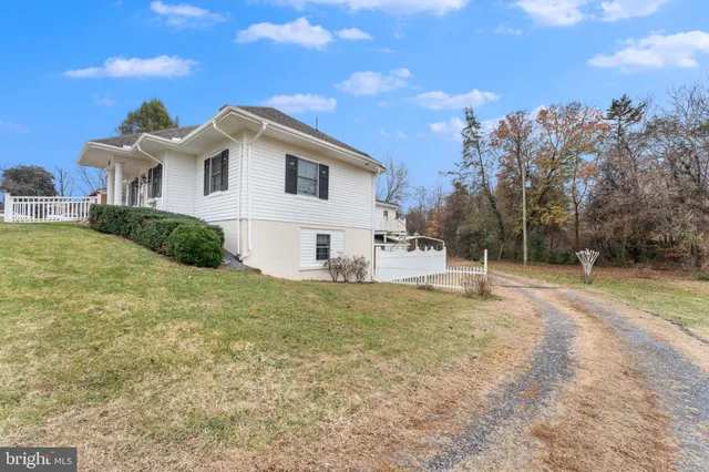 a view of a house with a wooden fence