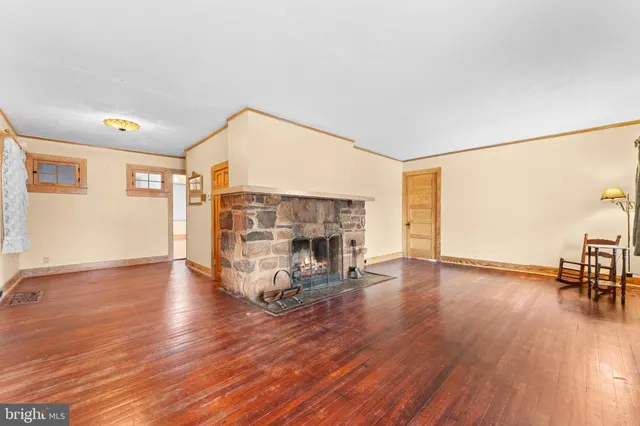 a view of a livingroom with furniture and a fireplace