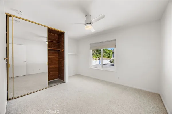 an empty room with windows and closet